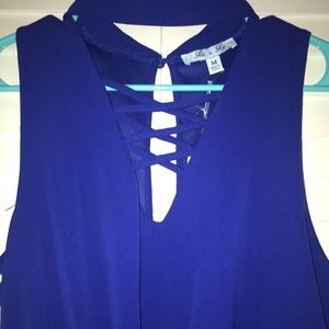 Blue romper with cross detailing and a collar